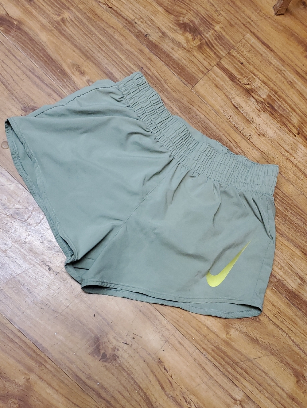 Nike Women's Sage Green Running Shorts with Yellow Swoosh
